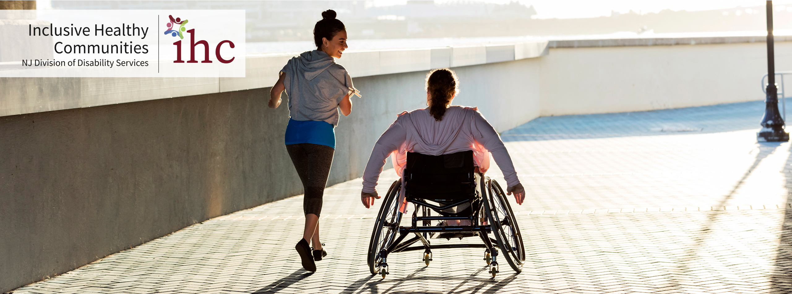 Woman running next to woman in wheelchair